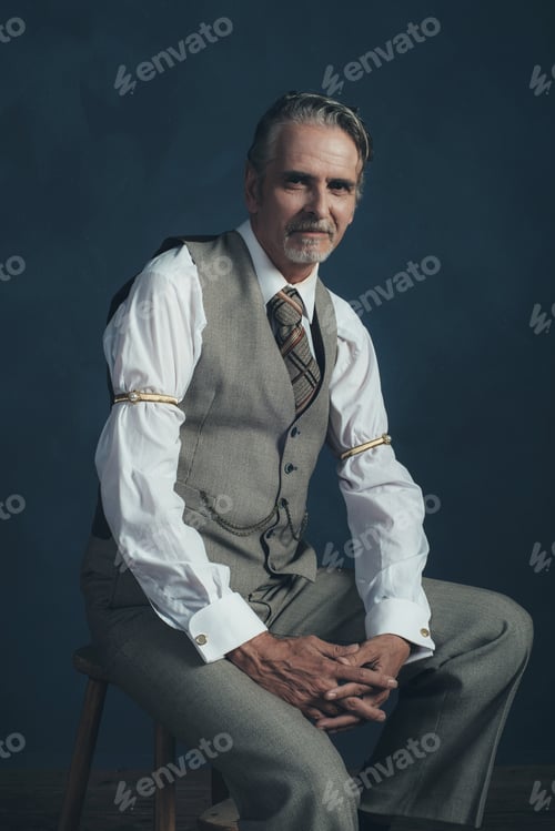 Preview: Confident Retro 1920S Fashion Man Sitting On Wooden Chair In Empty Room.