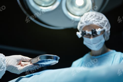 Preview: Surgical Assistant Holding Instrument During Operation