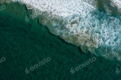 Preview: Aerial Surfers from above waiting for a wave at the beach