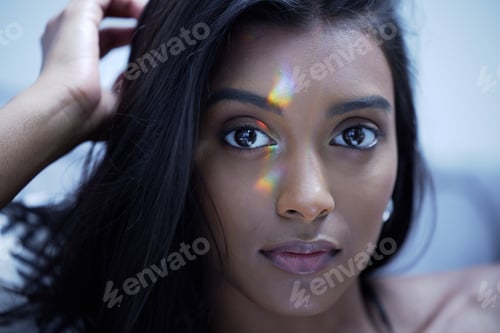 Preview: Shot of a young woman looking at the camera in a studio