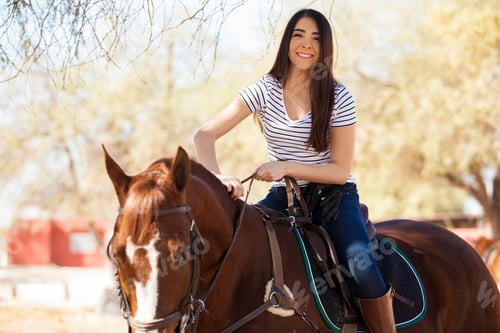 Preview: Portrait Of A Gorgeous Young Woman Riding Her Horse And Petting Him