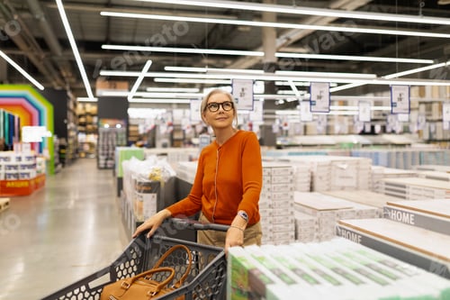 Preview: Shopping for home goods in a modern retail store during the day with a woman enjoying her experience