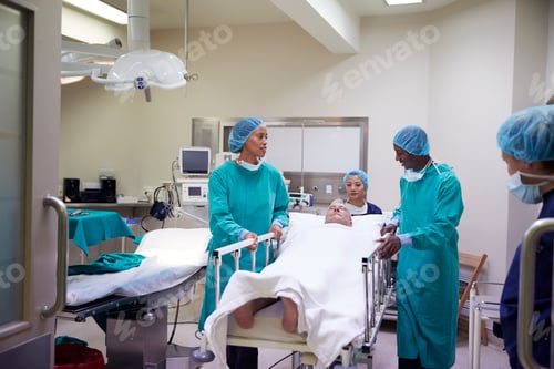 Preview: Surgical Team Wheeling Senior Male Patient Out Of Hospital Operating Theatre