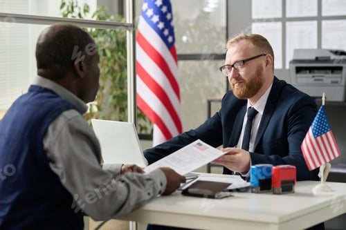 Preview: Worker handing visa application to man