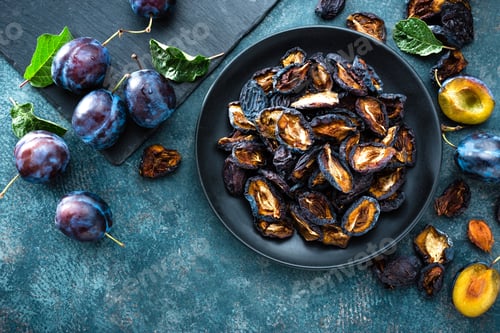 Preview: Dried prune and fresh plums with leaves
