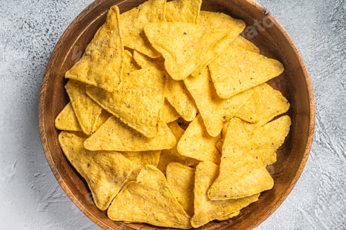 Preview: Mexican nachos corn chips in a wooden plate. White background. Top view