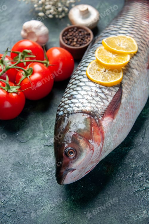 Preview: front view fresh raw fish with lemon slices and tomatoes on a dark blue background shark seafood