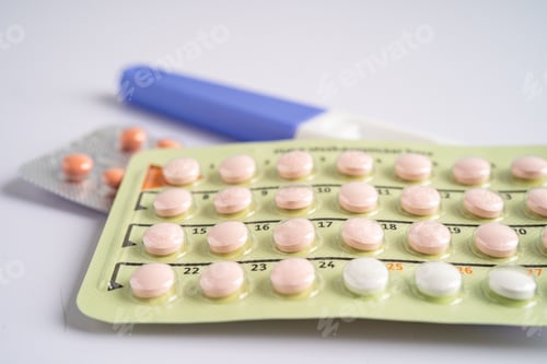 Preview: Pregnancy test and birth control pills on calendar, contraception health and medicine.