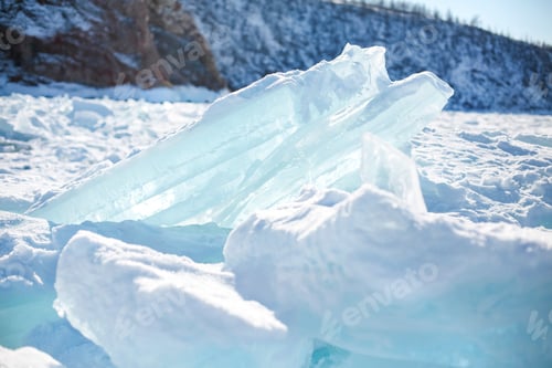 Preview: Pieces of ice lying on the ideal smooth ice of baikal with ice hummocks in the horizon