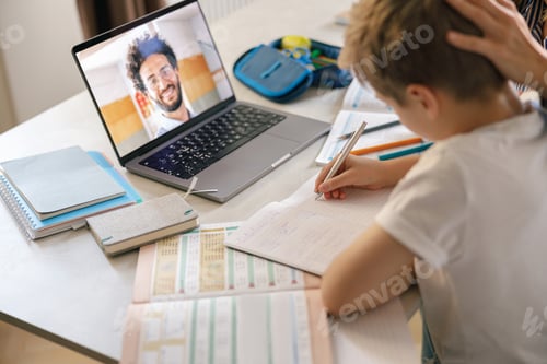 Preview: Boy Learning Online with Laptop at Table