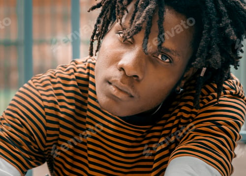 Preview: Portrait of young handsome stylish black man with natural hair afro dreadlocks. Afroamerican guy. St