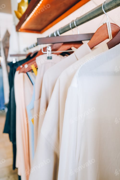 Preview: Rack with stylish women's clothes indoors in fashion store