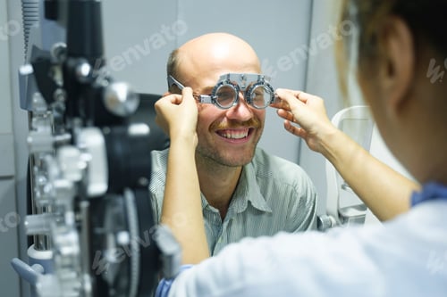 Preview: Man examining eyesight in optical clinic.