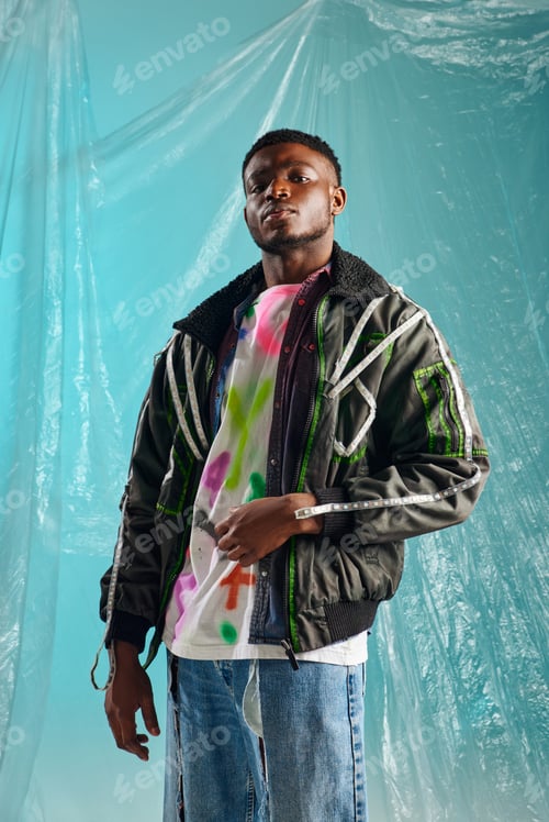 Preview: Confident young afroamerican model in ripped jeans and outwear jacket with led stripes