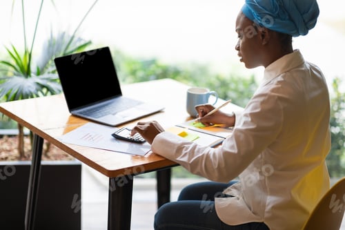 Preview: African american woman working on budget, sitting at cafe