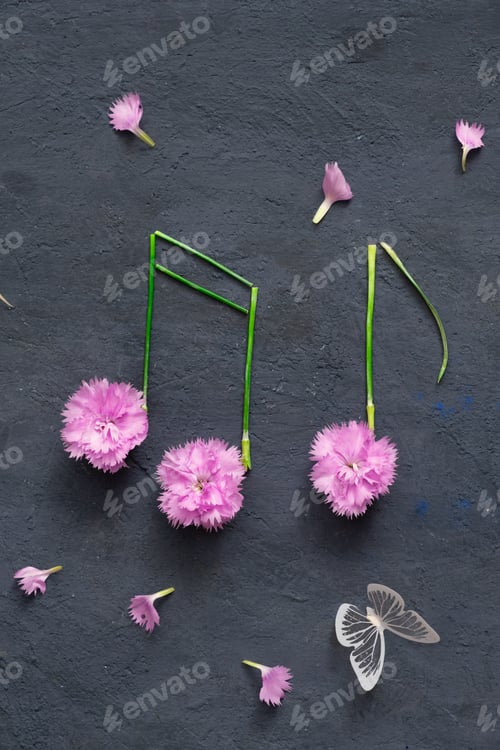 Preview: Butterfly and notes made from flowers and stems on dark background. Musical creative concept