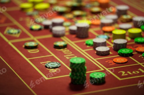 Preview: close-up of casino chips on the red table