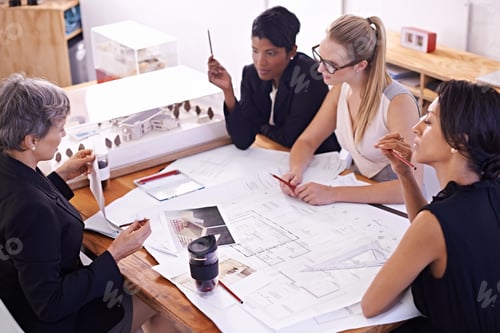 Preview: A group of female architects working together on a project at a conference table
