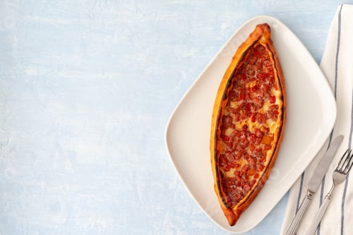 Preview: Turkish baked Pide bread on light blue wooden surface