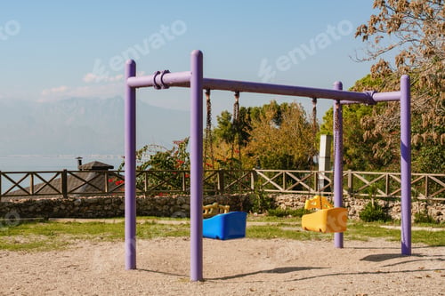 Preview: Empty Playground Swings With Mountain Sea View