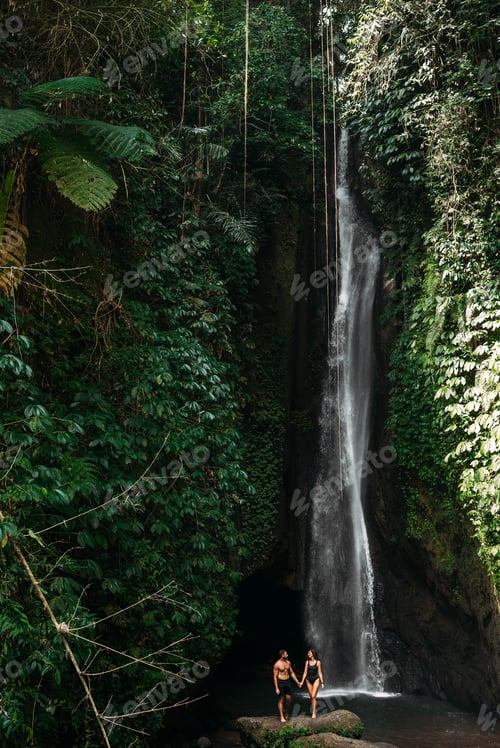 Preview: Couple at a tropical waterfall. The couple travels to the island of Bali in Indonesia