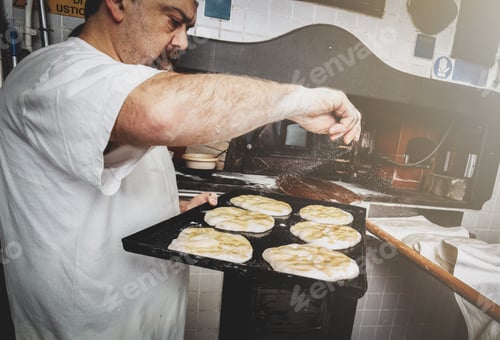 Preview: Production of baked bread with a wood oven in a bakery.