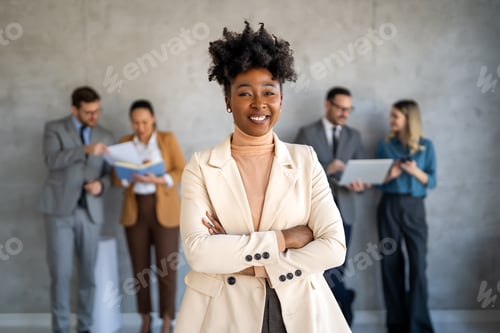 Preview: Group of young business people working as a team and communicating in corporate office