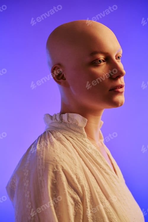Preview: Young Adult Woman with Alopecia Posing Against Purple Background