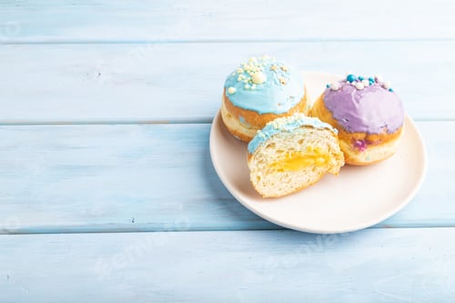 Preview: Purple and blue glazed donut on blue wooden, side view, copy space.