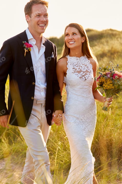 Preview: Romantic Married Couple Celebrating Beach Wedding Walking In Dunes Together
