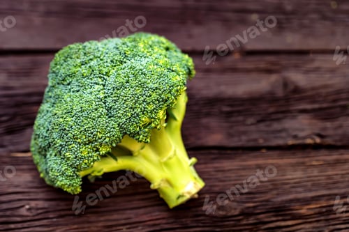 Preview: Green fresh broccoli on dark wooden surface