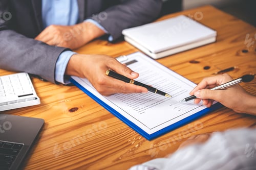 Preview: business people negotiating contracts with the documents on the table and sign the contract