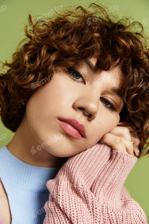 Preview: Young woman with short curly hair showcases summer fashion in vibrant green backdrop