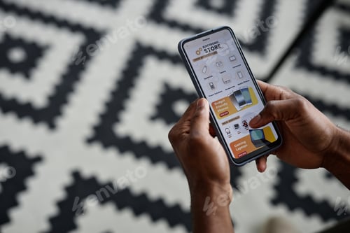 Preview: Hands Holding Smartphone With Store App On Screen
