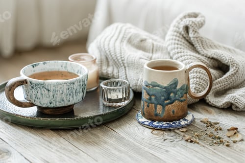 Preview: Cozy composition with ceramic cups and candles.