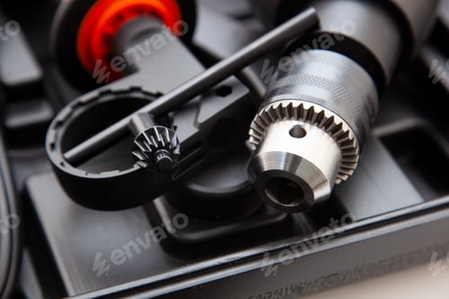 Preview: Electric drill in a suitcase. Keyless chuck. Gear teeth. Close-up tool. Metal details. Worker