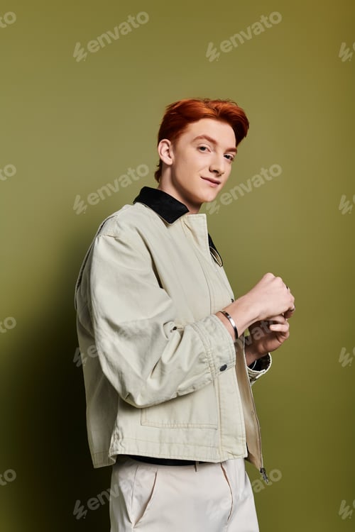 Preview: Young man with striking red hair showing emotion in a modern urban setting