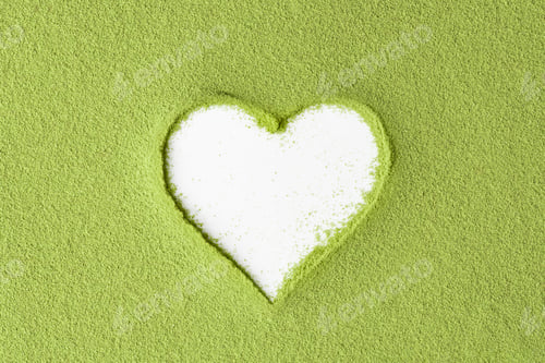 Preview: Creative mockup with heart-shaped cutout in vibrant green matcha powder on white background