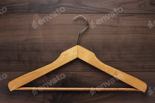 Preview: Wooden hanger on a brown wooden background