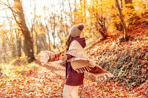 Preview: Woman having fun while spending sunny autumn day in nature