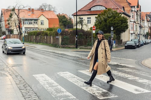 Preview: Young adult trendy stylish beautiful caucasian happy smiling woman enjoy walking by road crosswalk