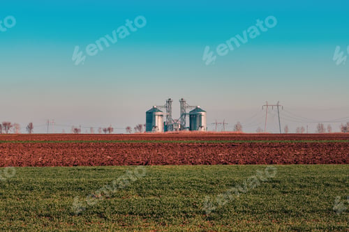 Preview: Grain storage silos, large agricultural building on farmland