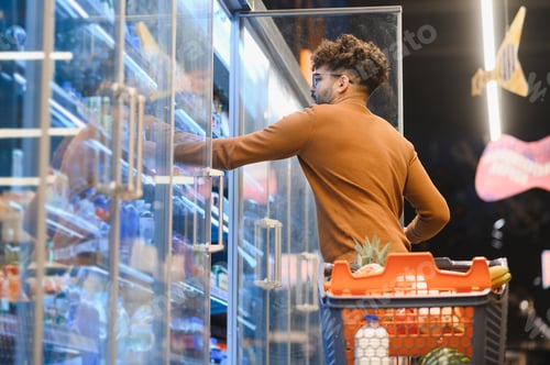 Preview: Customer choosing frozen food in supermarket refrigerator section