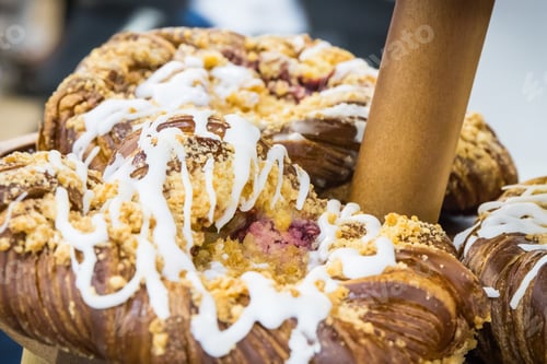 Preview: Crusty bun with icing on market stall, in cafe or in confectionery shop