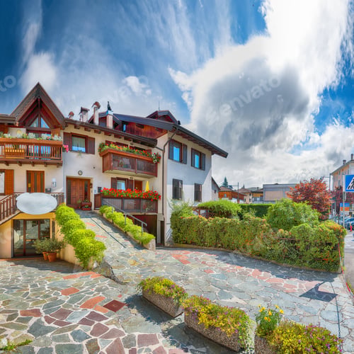 Preview: Awesome View of Traditional alpine houses with flowers on balcony the Cles city.