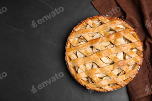 Preview: Delicious traditional apple pie on black table, top view. Space for text