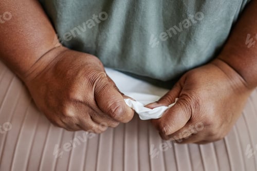 Preview: Closeup of black senior woman holding tissue and crying