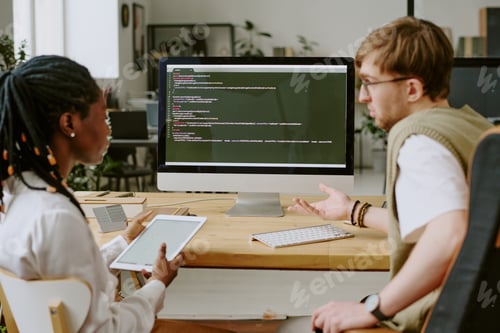Preview: Biracial Team of Developers Discussing Codes