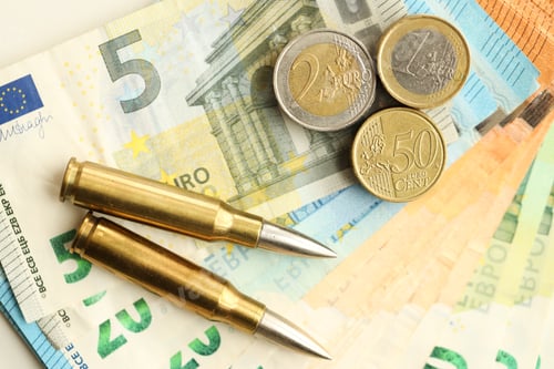 Preview: Yellow cartridges and shell casings on euro banknotes. Lot of bills of European union currency