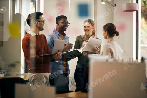 Preview: Young start-up team talking and having fun while working at creative office.
